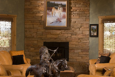 Inspiration for a large rustic enclosed medium tone wood floor family room remodel in Denver with gray walls, a standard fireplace, a stone fireplace and no tv