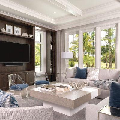 Inspiration for a mediterranean family room remodel in Miami with a media wall