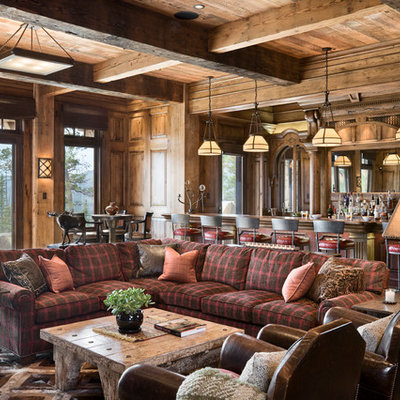 Example of a mountain style open concept family room design in Other with a bar, brown walls and no fireplace