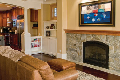 Traditional enclosed games room in Seattle with yellow walls, dark hardwood flooring, a standard fireplace, a stone fireplace surround and a concealed tv.