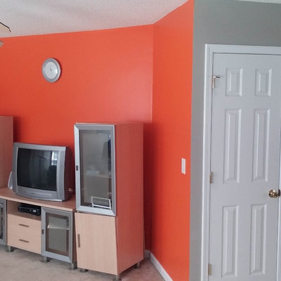 Example of a mid-sized minimalist carpeted family room design in Charlotte with multicolored walls and a tv stand