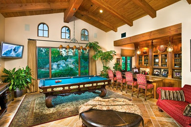 Game room - large traditional brown floor game room idea in San Diego with beige walls and a wall-mounted tv