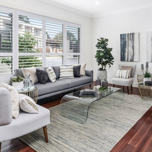 Transitional family room in Sydney with white walls, medium hardwood floors and brown floor.