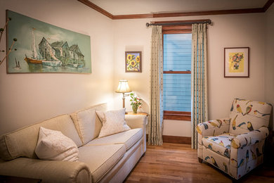 Ejemplo de sala de estar cerrada tradicional de tamaño medio sin chimenea con suelo marrón, paredes grises y suelo de madera en tonos medios