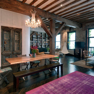 Inspiration for an industrial dark wood floor family room remodel in New York with a wall-mounted tv and white walls