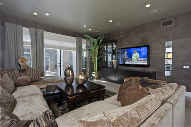 Example of a mid-sized transitional enclosed terra-cotta tile and beige floor family room design in Orange County with a bar, gray walls, no fireplace and a wall-mounted tv
