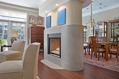 Family room - modern family room idea in Tampa with a two-sided fireplace and a concrete fireplace
