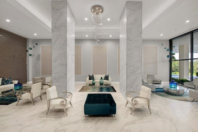 На фото: огромная открытая гостиная комната в современном стиле с серыми стенами, полом из керамогранита и белым полом без телевизора с