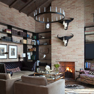 Example of a mountain style dark wood floor family room design in Austin with a standard fireplace and a brick fireplace