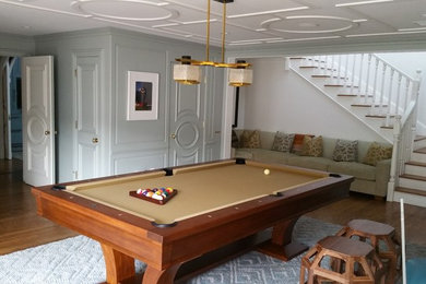 Inspiration for a large traditional enclosed games room in Los Angeles with white walls, light hardwood flooring, no fireplace, no tv and brown floors.