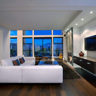 Example of a large trendy open concept dark wood floor family room design in Vancouver with a standard fireplace and a wall-mounted tv