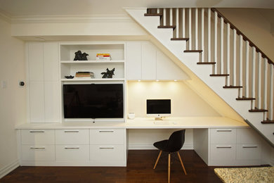 Family room - small contemporary open concept medium tone wood floor family room idea in Toronto with no fireplace, a media wall and white walls