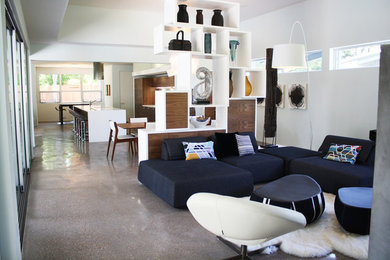 Large minimalist open concept concrete floor family room photo in Austin with gray walls