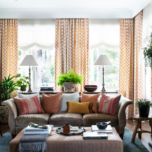 Design ideas for a transitional family room in Sydney with beige walls, medium hardwood floors, a standard fireplace and brown floor.