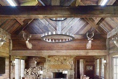 Inspiration for a rustic open concept family room remodel in Birmingham with brown walls, a standard fireplace and a stone fireplace