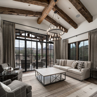 Family room - huge rustic open concept medium tone wood floor and brown floor family room idea in Phoenix with white walls, a standard fireplace, a stone fireplace and a media wall