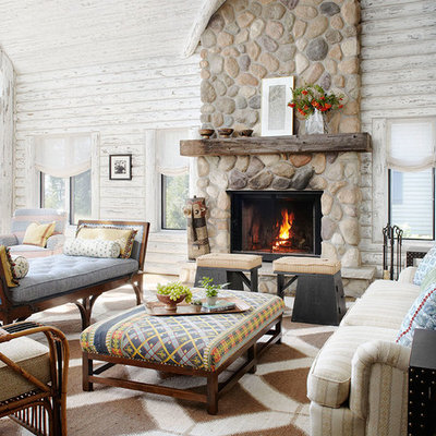 Inspiration for a rustic family room remodel in Milwaukee with white walls, a standard fireplace and a stone fireplace