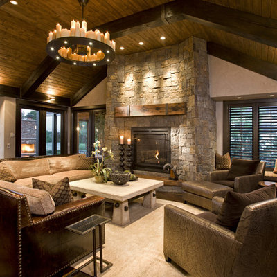 Mountain style family room photo in Minneapolis with a stone fireplace