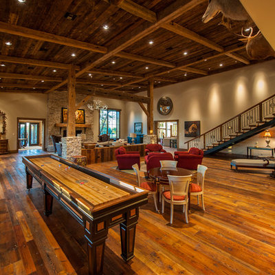 Game room - rustic open concept dark wood floor game room idea in Austin with beige walls