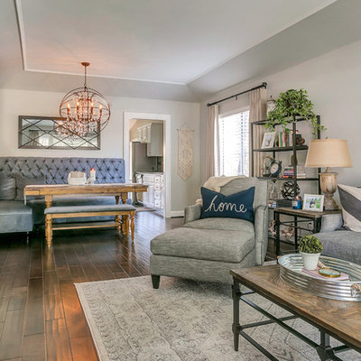 Large mountain style open concept medium tone wood floor family room photo in Los Angeles with gray walls, no fireplace and a wall-mounted tv