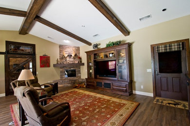 Rustic games room in Phoenix with a stone fireplace surround.