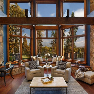 Mountain style medium tone wood floor family room photo in Dallas with blue walls and a wall-mounted tv