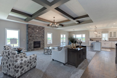 Inspiration for a mid-sized transitional open concept carpeted, gray floor and wood ceiling family room remodel in Omaha with no tv, gray walls, a standard fireplace and a stone fireplace