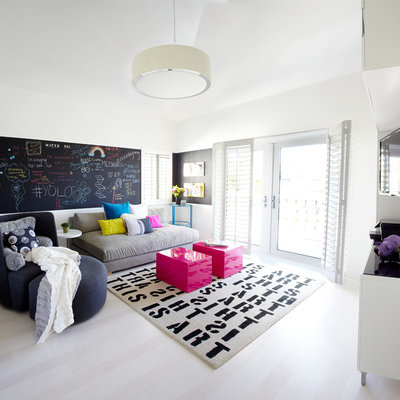 Inspiration for a mid-sized contemporary open concept light wood floor family room remodel in Orange County with white walls and a wall-mounted tv