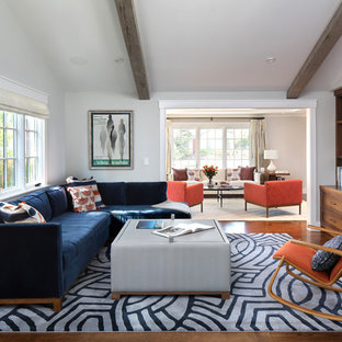 Example of a large 1950s dark wood floor family room design in San Francisco with no fireplace, a media wall and gray walls