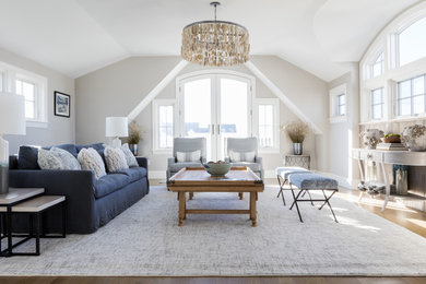 Inspiration for a coastal medium tone wood floor and brown floor family room remodel in Boston with beige walls