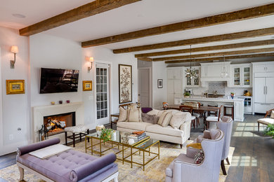Example of a mid-sized classic open concept dark wood floor and brown floor family room design in Atlanta with white walls, a standard fireplace and a wall-mounted tv