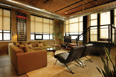 Ejemplo de sala de estar tipo loft moderna de tamaño medio con suelo de cemento