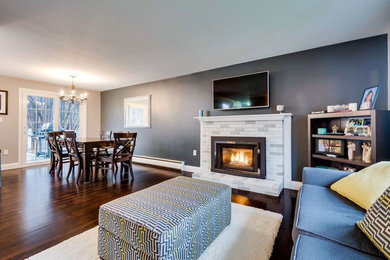 Mid-sized transitional open concept dark wood floor and brown floor family room photo in Boston with gray walls, a standard fireplace, a plaster fireplace and a wall-mounted tv