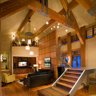 Inspiration for a large rustic open concept light wood floor and brown floor family room remodel in Other with beige walls, no fireplace and a media wall