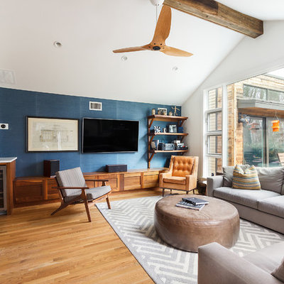 Family room - contemporary open concept medium tone wood floor family room idea in DC Metro with blue walls, no fireplace and a wall-mounted tv