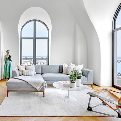 Example of a large trendy open concept light wood floor family room design in Chicago with white walls
