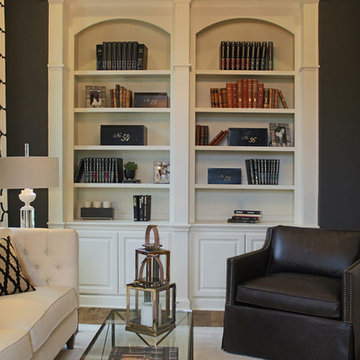 Sitting room with built in arched bookshelves in white
