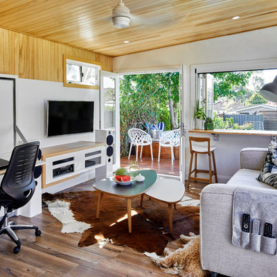 Small trendy open concept medium tone wood floor family room photo in Sydney with white walls and a wall-mounted tv