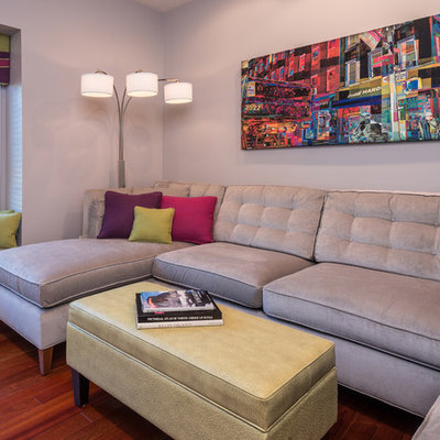 Inspiration for a small contemporary medium tone wood floor family room remodel in Other with gray walls and a wall-mounted tv