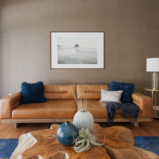Design ideas for a mid-sized transitional open concept family room in Phoenix with beige walls, no tv, medium hardwood floors and brown floor.