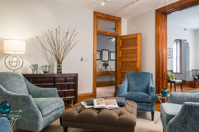 Ejemplo de sala de estar cerrada tradicional de tamaño medio sin chimenea con paredes beige y suelo de madera en tonos medios