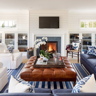 Example of a large beach style open concept light wood floor family room design in New York with white walls, a standard fireplace, a wall-mounted tv and a tile fireplace