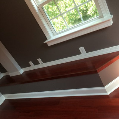 Example of an arts and crafts loft-style dark wood floor family room design in Raleigh with multicolored walls