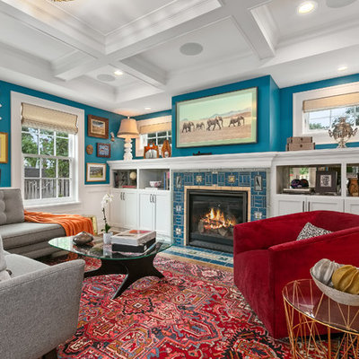 Inspiration for a mid-sized eclectic enclosed brown floor and medium tone wood floor family room remodel in Minneapolis with blue walls and a standard fireplace