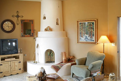Example of a southwest enclosed family room design in Albuquerque with beige walls and a tv stand