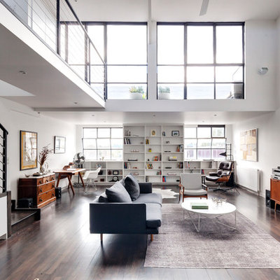 Example of a trendy dark wood floor family room library design in Melbourne with white walls, no fireplace and a tv stand