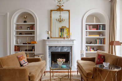 Inspiration for a transitional medium tone wood floor and brown floor family room remodel in Philadelphia with white walls and a standard fireplace