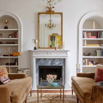 Inspiration for a transitional medium tone wood floor and brown floor family room remodel in Philadelphia with white walls and a standard fireplace