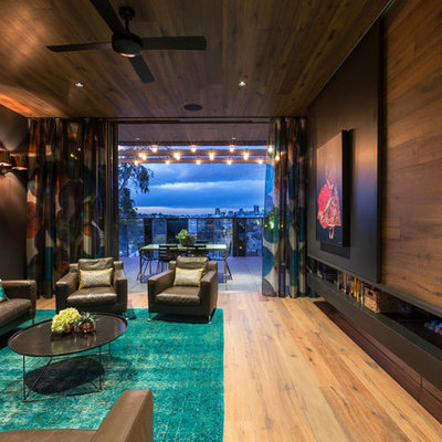 Inspiration for a contemporary enclosed light wood floor family room remodel in Melbourne with brown walls, a ribbon fireplace and a wood fireplace surround