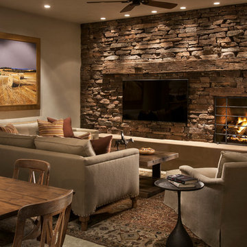 Stacked stone and a reclaimed beam mantel give an earthy texture to this casual